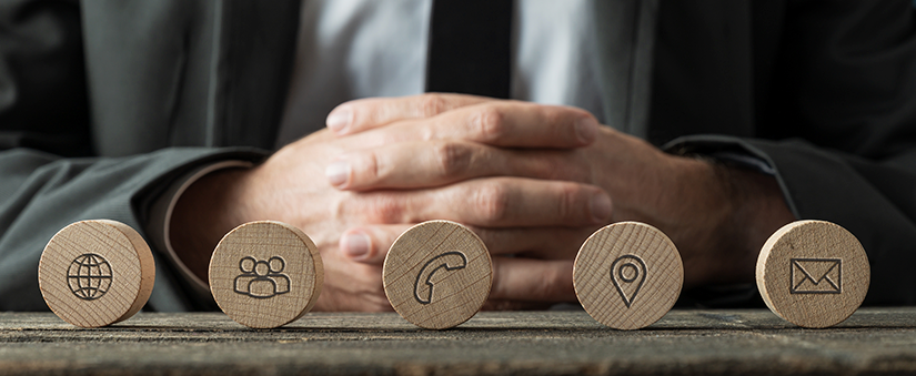 Fluxo de cadência: bolinhas de madeira com ícones de "telefone", "localização", "internet" e outros aparecem em primeiro plano, enquanto mãos cruzadas tomam o fundo da imagem.