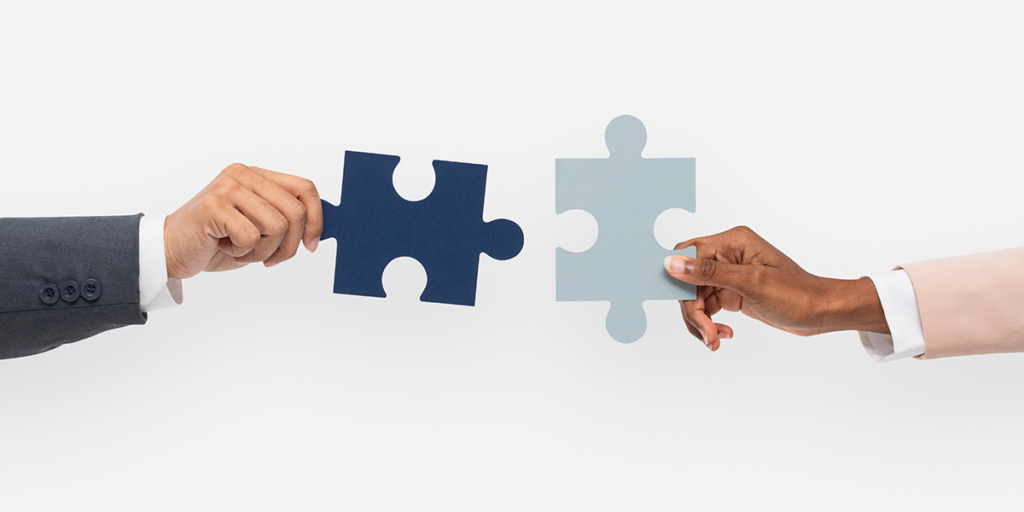 loteadora loteadora: imagem de duas mãos segurando peças de quebra-cabeça.