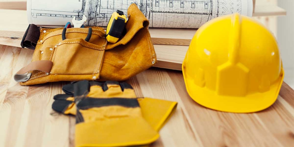 setor da construção setor da construção: imagem de luvas, capacete e um cinto com alguns itens de construção.