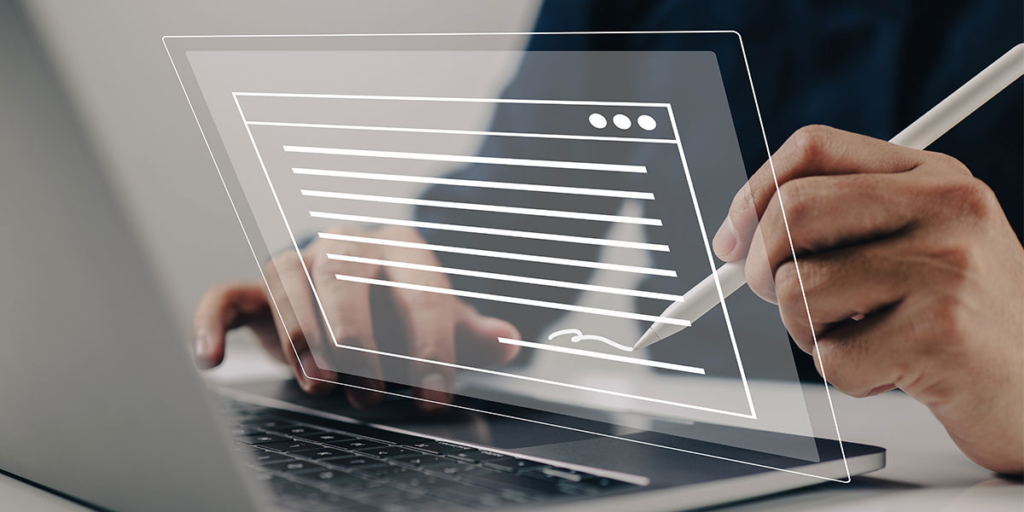 emissão de contrato emissão de contrato: close em mãos na frente de um notebook. Com uma das mãos, a pessoa assina um papel em holograma.