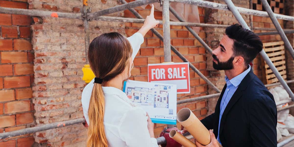Dia do Engenheiro Civil Dia do Engenheiro Civil: imagem de um homem e uma mulher segurando plantas de imóvel e apontando para um andaime numa construção.