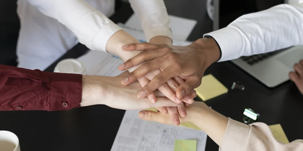 Pós venda imobiliário Pós venda imobiliário: imagem de mãos juntas vistas de cima.