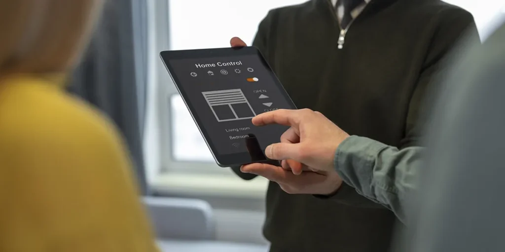 Automação com CRM imobiliário: a imagem apresenta um homem segurando um tablet enquanto o outro está com o dedo na tela.